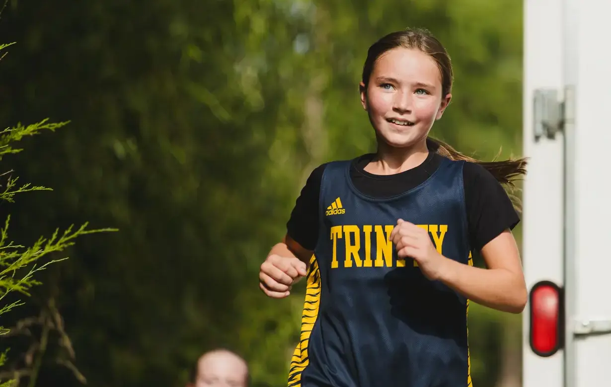 Middle school female student running outdoors