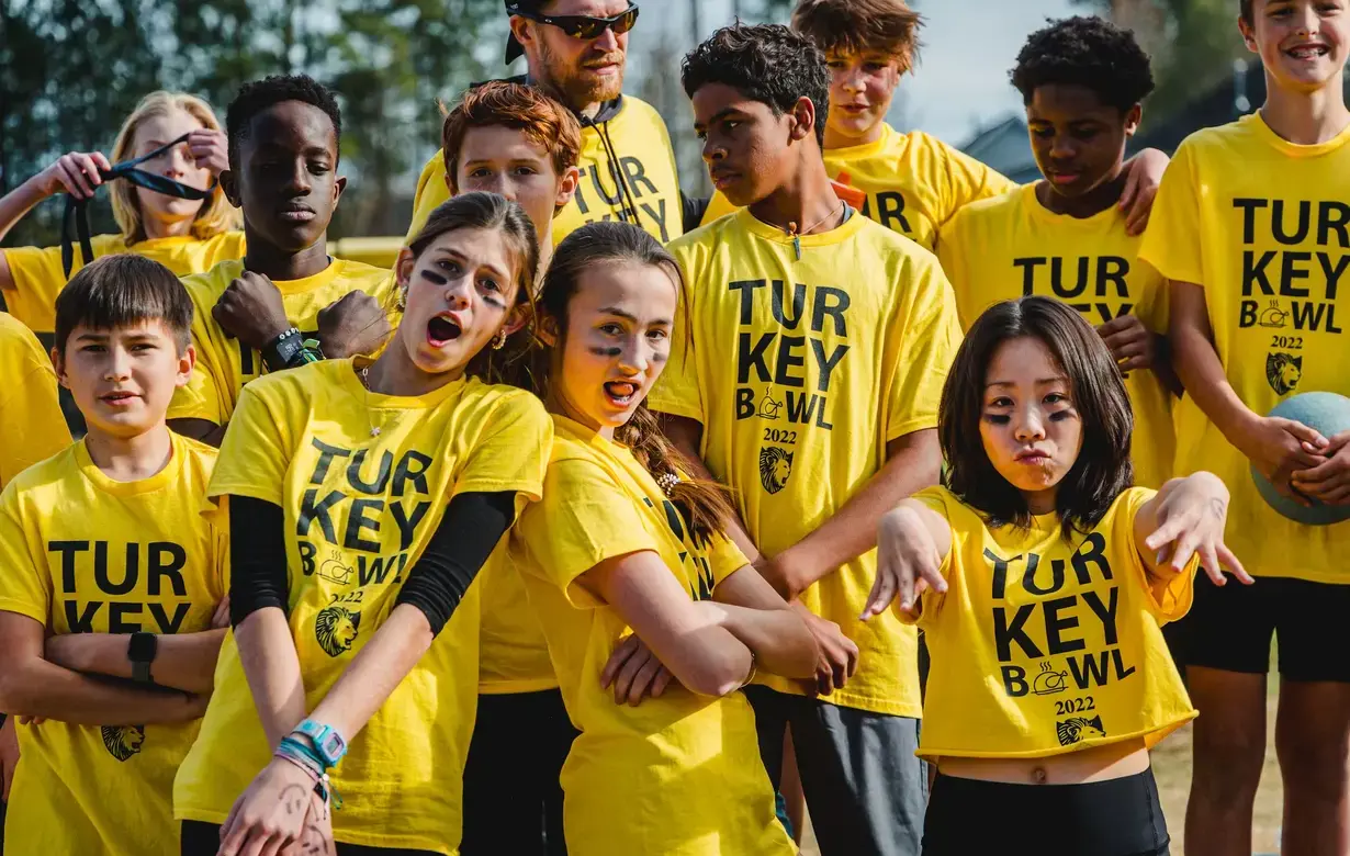 Group of Middle School students wearing sports tour t-shirts