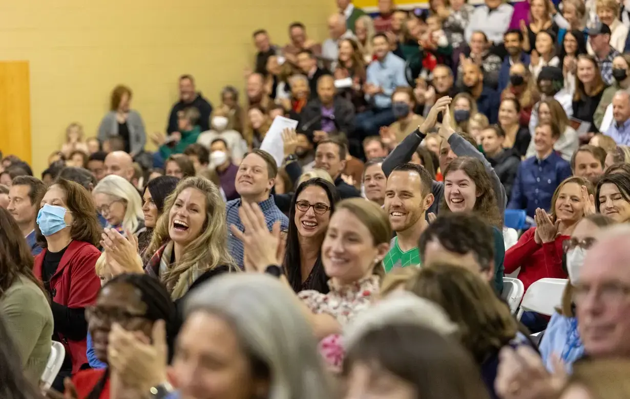 Group of Trinity parents applauding joyfully