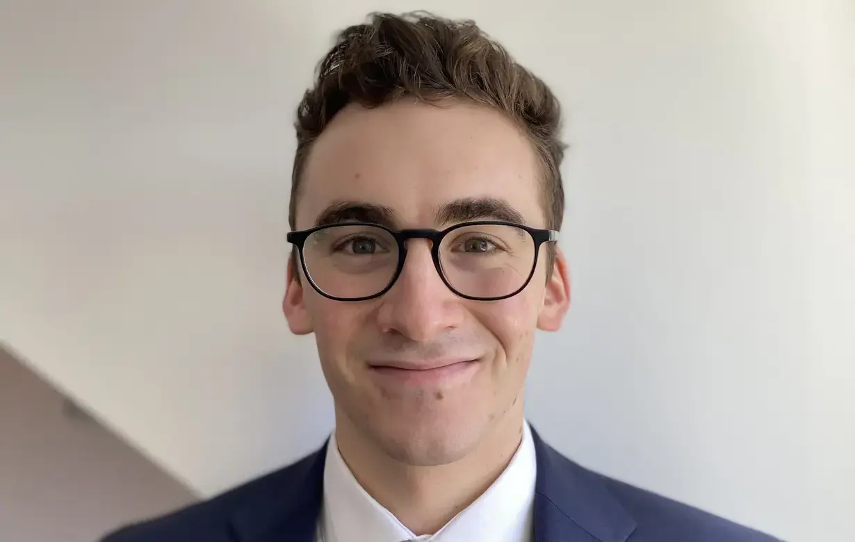 Close up image of a young man named Philip Lindia smiling at the camera