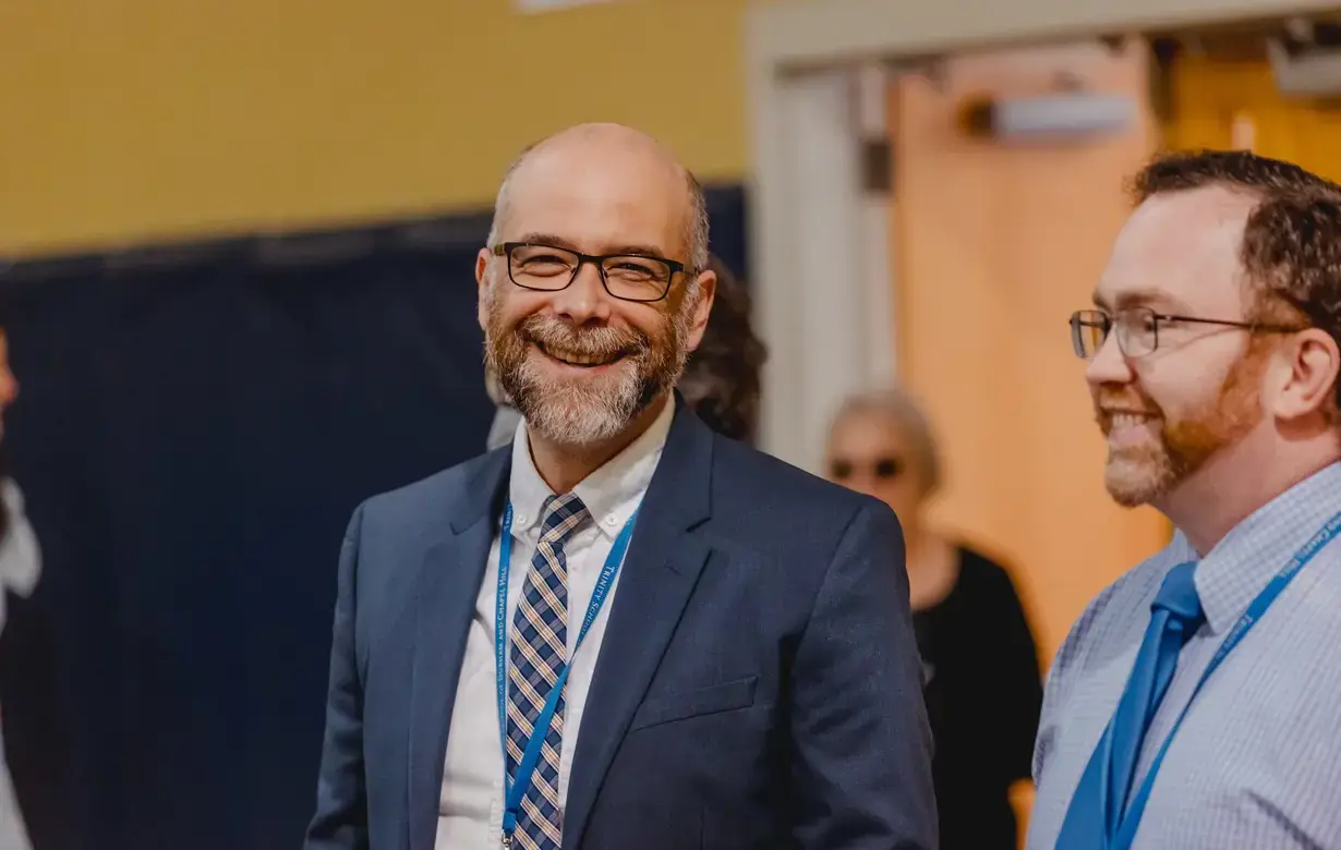 Member of Trinity School faculty smiling at camera